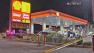 Police are seen at a gas station in Colton where a corrections officer was shot Thursday, May 2, 2013. The officers condition is unknown.