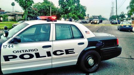 An Ontario police vehicle is shown behind crime tape at a scene of a barricade on Benson Avenue in Ontario on Friday, June 7, 2013.