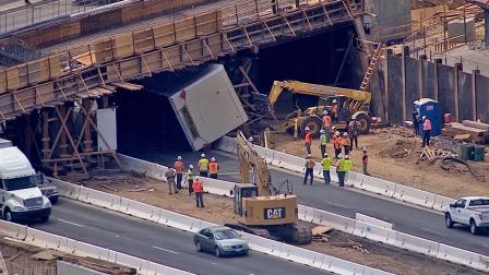 A big rig struck an overpass and got stuck underneath it on the 215 Freeway in Perris on Tuesday, July 9, 2013.