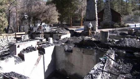 A Big Bear-area cabin where fugitive Chris Dorner is believed to have died on Wednesday, Feb. 13, 2013, is seen after the structure went up in flames.