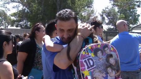 Yuri Furlong is reunited with his daughter after a bomb threat locked down Mango Elementary School in Fontana on Friday, Sept. 13, 2013.