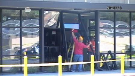Workers are seen repairing broken windows and doors at the DMV located on North Waterman Avenue in San Bernardino Saturday, Sept. 14, 2013.