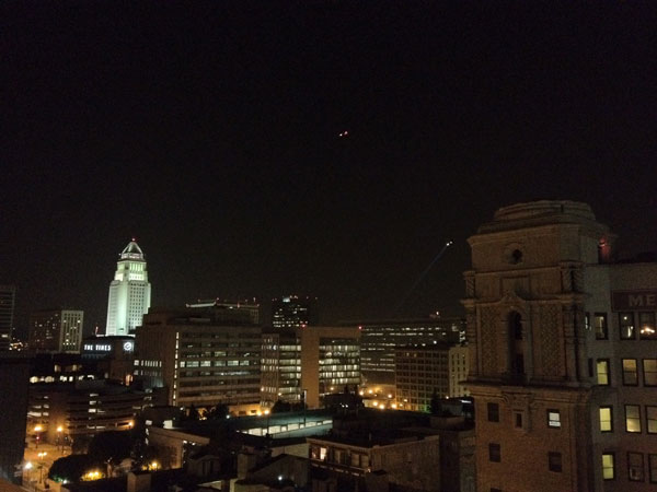 A police helicopter flies over the Occupy Los...