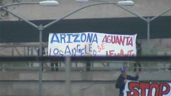 Activists waved banners protesting Arizona's anti-immigration law off of several major L.A.-area freeway overpasses on Monday, July 26, 2010.