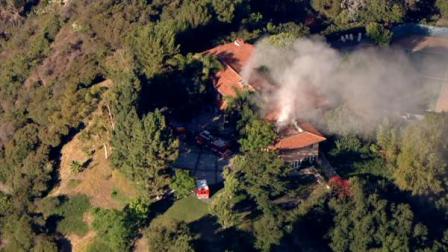 Firefighters battled a fire at a mansion in the Beverly Glen area of Los Angeles on Tuesday morning.