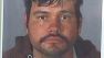 Police on Tuesday named a suspect in the killing of a Valley Village woman, whose body was found in her burned-out home.