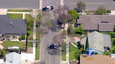 A neighborhood in Long Beach was evacuated after two burglary suspects barricaded themselves inside a home on Friday.