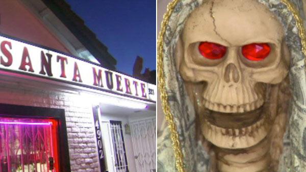 Inside the storefront of a Los Angeles temple, near the votive candles and religious posters, lays an ominous figure that's impossible to miss: a skeleton wrapped in a shroud made to look like money. She is Santa Muerte, and her reach is spreading.