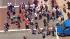 Skateboarders spill onto an intersection in...