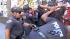 LAPD officers pat down skateboarders in downtown...