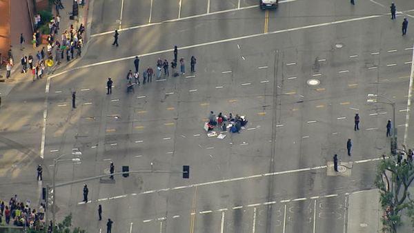 Protesters formed a circle in the middle of the intersection at Westwood and Wilshire Boulevards on Wednesday, Nov. 9, 2011, shutting down the busy roadway.