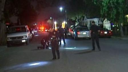 Authorities investigate the scene of a fatal shooting in South Los Angeles on Wednesday, Feb. 22, 2012.