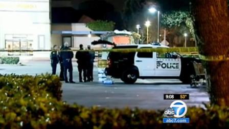 Pasadena police officers stand near the scene of a fatal officer-involved shooting involving a robbery suspect on Saturday, March 24, 2012.