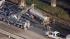 A scorched fuel tanker is hauled onto a tow...