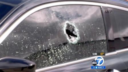 A bullet hole cracks a car window after a 21-year-old driver was struck in the ear while in his car along the 110 Freeway.