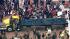 A truck hauling demonstrators stops momentarily...