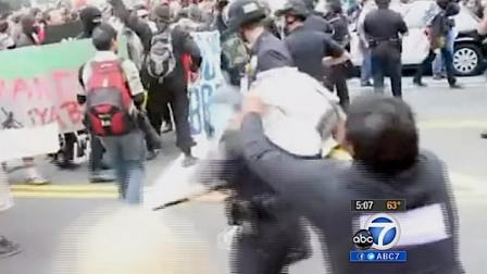 A man is seen attacking a Los Angeles police officer during a May Day protest on May 1, 2012.