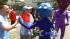 Costumed parade-goers walk along the parade...