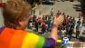 A woman waives at a crowd of spectators at the 42nd annual L.A. Pride Parade held in West Hollywood on Sunday, June 10, 2012.