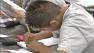 A student is shown writing in this undated file photo.