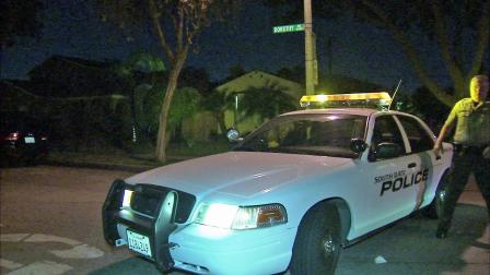 A sheriffs deputy is seen on Dorothy Avenue in South Gate where a double shooting happened Sunday, July 1, 2012.