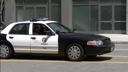 An LAPD patrol car and two officers are seen in this file photo.