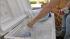 Clarita residents seek refuge from sun :: A woman is seen reaching for a water bottle from an ice chest during a hot summer day in the Santa Clairta Valley in this file photo.