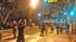 A line of LAPD officers is seen moving in on a...