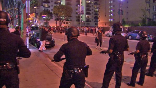 A line of LAPD officers is seen in downtown Los Angeles after a protest during the monthly Art Walk on Thursday, July 12, 2012.