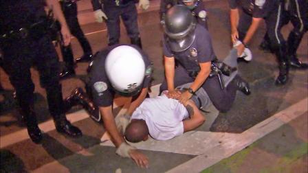 LAPD officers are seen preparing to handcuff a man during a clash with Occupy LA protesters at the Downtown LA Art Walk on Thursday, July 12, 2012.