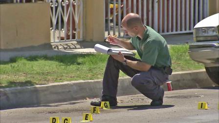 An investigator is seen at the site of a shooting in Norwalk that killed a man on Sunday, August 12, 2012.