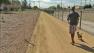 A man is seen walking his dog through a revitalized portion of the Tujunga Wash in this undated file photo.