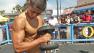 A man lifts a weight in Venice Beach on Monday, Sept. 3, 2012.