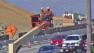 Workers are seen next to the 405 Freeway near the Sepulveda Pass on Friday, Sept. 7, 2012.