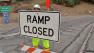 Workers post signs next to the 405 Freeway near the Sepulveda Pass in this file photo.