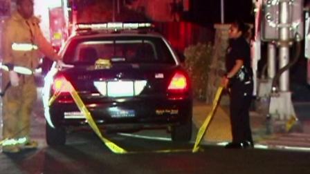 A police car is parked at the scene of a shooting in Highland Park, Los Angeles, on Monday, Sept. 17, 2012.