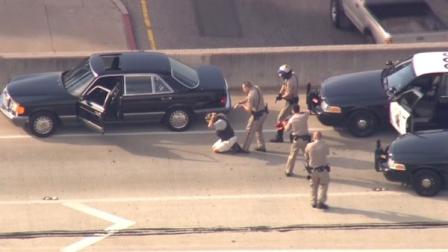 A pursuit suspect kneels as officers approach him on the southbound 101 Freeway following a high-speed chase on Friday, Sept. 28, 2012.