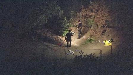 Investigators combed an area near the Golden State (5) Freeway in Burbank for clues after a mans body was found on Tuesday, Oct. 2, 2012.