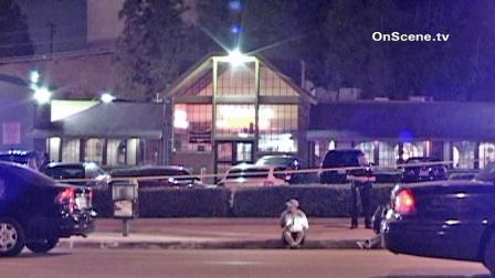 Police are seen outside a Shakeys in Monterey Park where a man was shot and killed Saturday, Oct. 6, 2012.