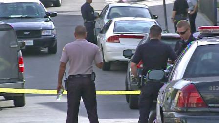 Investigators surround the scene of an officer-involved shooting in the Jefferson Park area on Saturday, Oct. 6, 2012.