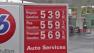 A sign displaying gas prices is pictured.