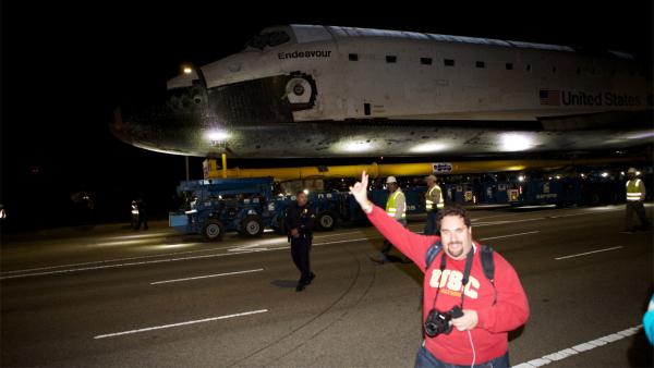ABC7 viewer Victor Orly stands in front of space shuttle Endeavour along Westchester Parkway on Friday, Oct. 12, 2012.