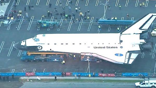 Space shuttle Endeavour makes a stop at a private parking lot before continuing on its 12-mile journey to the California Science Center on Friday, Oct. 12, 2012.