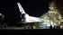 The space shuttle Endeavour moves slowly into...