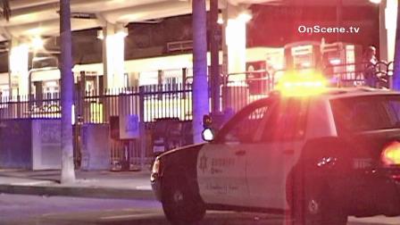 Authorities are seen at the Blue Line station in Long Beach following a stabbing on Sunday, Oct. 21, 2012.