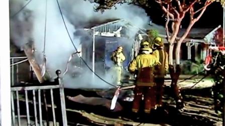 Firefighters are seen at a mens group home that burned down in Pasadena on Thursday, Nov. 1, 2012.