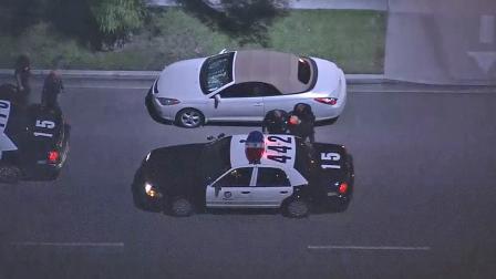 A pursuit suspect is shown being detained by law enforcement after a pursuit in North Hollywood on Friday, Nov. 2, 2012.