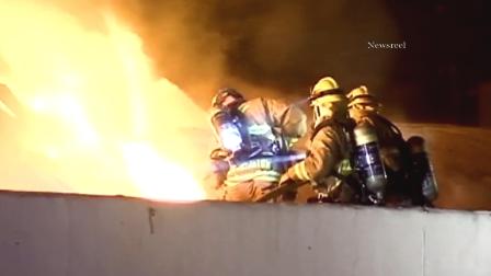 Firefighters battle a structure fire at the intersection of Victory Boulevard and North Manning Street on Friday, Nov. 9, 2012.