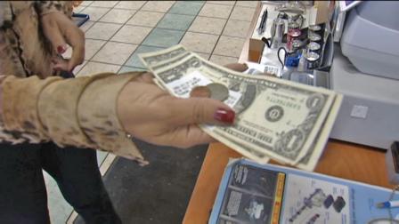 A store customer receives cash back at a Los Angeles business.