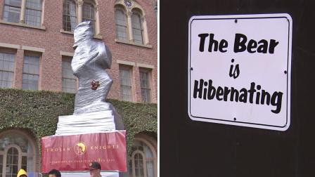 A statue of USC mascot Tommy Trojan (left) is seen in bubble wrap and a plywood box housing UCLA mascot Joe Bruin (right) is seen with a sign that reads The Bear is Hibernating, in this photo from Friday, Nov. 16, 2012.